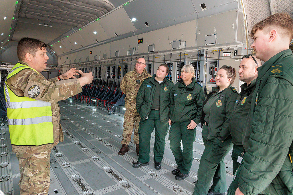 Members of the South Central Ambulance Service receive a briefing, while standing in the Atlas C Mk.1 cargo bay